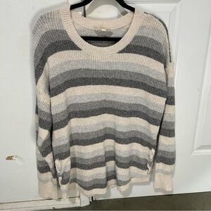 Woman’s, cream, light, grey, and dark grey striped knitted sweater.
